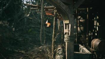 CGI Rustic wooden structure with hanging lantern and ropes in natural setting video