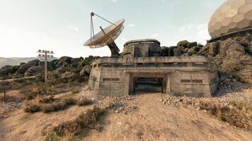 CGI Abandoned communication facility surrounded by rocky terrain under sunlight video