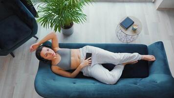 Woman in wireless headphones listening to music and using mobile apps or video