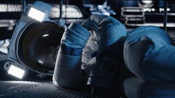 Cosmonaut collapses from sudden illness during major space station failure starting critical alert. Warning lights flashing over unconscious astronaut suffering medical crisis in spacecraft, camera B video
