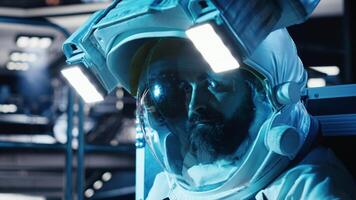 Burnout cosmonaut feeling emotional toll inside silent orbital station. Lonely astronaut stares blankly across spaceship cockpit after extended mission time in complete isolation, camera B video