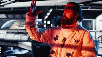 Starship cockpit glowing as cosmonaut watches unknown alien vessel approach from deep space. Man reacts to unidentified extraterrestrial presence hovering near orbital station, camera B video