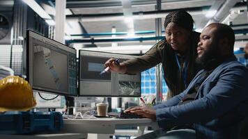 African american industry experts and engineers analyzing solar panel systems during a production inspection, engineering accuracy, quality control and factory operations. Camera B. video