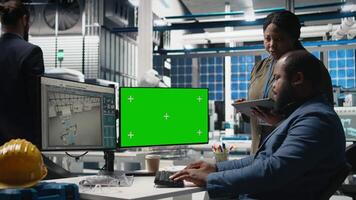 Professionals brainstorming solutions with mockup screen in solar facility, advancing industrial goals through collaboration and corporate responsibility. Team of engineers share insight. Camera B. video