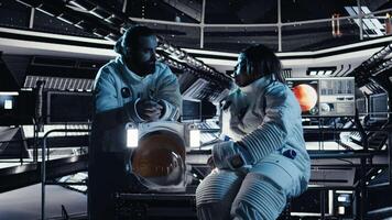 Teamworking cosmonauts chatting, exploring deep space during mankind survival expedition. Astronauts doing human expansion in space mission in spacecraft powered by advanced engineering, camera A video
