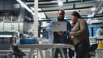 African American industrial coworkers doing teamwork on production line for solar panels, combining technical insight and teamwork to drive forward clean energy infrastructure. Camera B. video