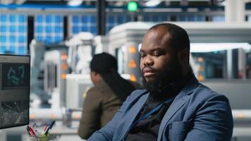 African american master engineers examining photovoltaics activity in solar power factory, reviewing data and checklists for the manufacturing process. Eco friendly renewable energy. Camera A. video
