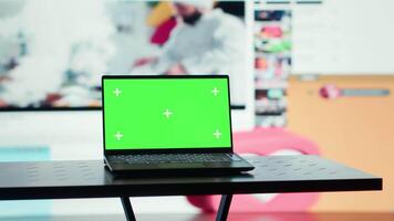 Chroma key notebook and wall stacked with diverse entertainment media channels. Isolated screen laptop in front of digital backdrop displaying social networks feed activity video