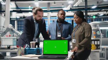 Multiethnic team of high tech experts work with copy space in a solar energy factory, shares ideas on improving systems and emphasizing strategic planning for technical development. Camera B. video