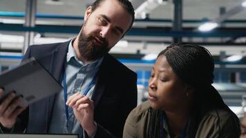 Group of professional consultants reviewing data and checklists in a high tech solar panel plant, ensuring manufacturing process meets sustainable energy and innovation standards. Camera A. video