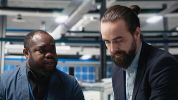 Engineering professionals and executive directors review operational workflows in a solar manufacturing facility. Integrating teamwork in renewable energy production and development. Camera A. video