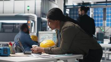 General manager reviewing production line system in a solar facility used for manufacturing, illustrating corporate efficiency for renewable energy within industrial operations. Camera A. video