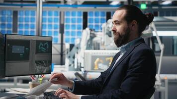 Professional engineer reviewing insight on pc at the solar panels plant, conducting an inspection to ensure alternative energy systems for production line and development goals. Camera A. video