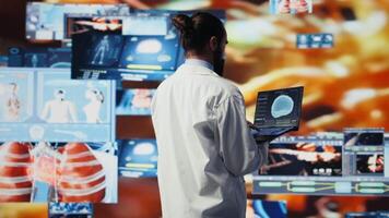 General practitioner leverages digital tools for better diagnostics and patient analysis, reflecting the future of medicine through technology and scientific advancement. Health innovation. Camera B. video