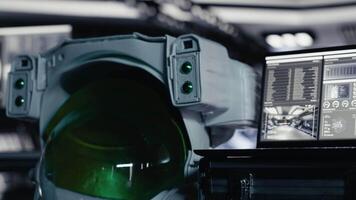 Close up of accident red light alert flashing over space helmet next to laptop in spaceship showing mission logs. Critical risk warning blinking over astronaut gear prepared for planetary expedition video