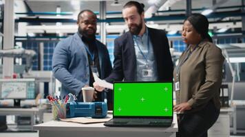 Diverse team members overseeing factory activity next to green screen, blending professionalism and technical expertise in the world of sustainable industrial energy. Cheaper power. Camera B. video