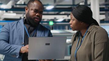 Black engineering professionals and directors review operational workflows in a solar manufacturing facility. Integrating teamwork in renewable energy production and development. Camera A. video
