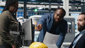 Diverse coworkers group in the factory handles solar power production line, showing teamwork in manufacturing systems of photovoltaics. Clean alternative energy management in plant. Camera A. video