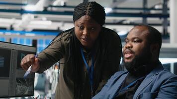 African american industry experts and engineers analyzing solar panel systems during a production inspection, engineering accuracy, quality control and factory operations. Camera A. video