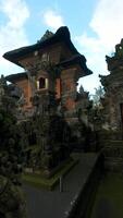 FPV drone flying through traditional Balinese temple interior with stone statues in Bali, Indonesia. Concepts of Bali culture, travel and architecture. video