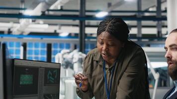 Multiethnic team of experts sharing details for the photovoltaics production line, examining metrics to guarantee manufacturing solar panels for renewable energy. Sustainability. Camera A. video
