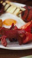 Tasty breakfast spread with eggs and grilled sausages video