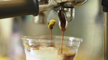 Freshly brewed espresso poured over ice in cafe video