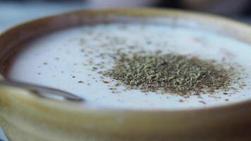Creamy soup topped with spices for flavor enhancement video