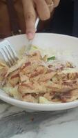 Grilled chicken served on a bed of fettuccine pasta video