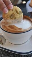 Enjoying a cookie with coffee at a local cafe video