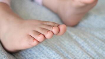 Close view of a child's toes relaxing on a blanket video