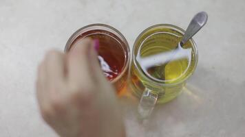 Close of making a cup of decaffeinated black tea with a fresh tea bag in hot water. video