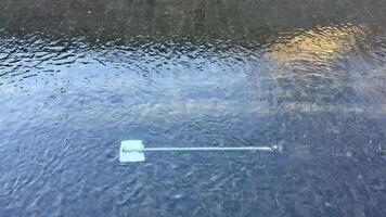 A calm and serene view of a paddle gently resting atop the still water, beautifully reflecting natures tranquility photo