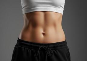 Woman's Fit Torso in Sportswear Against Gray Backdrop photo