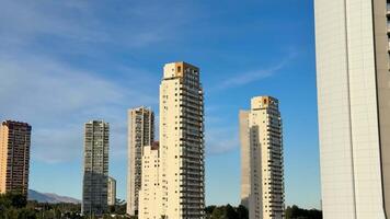 A breathtaking and stunning view of sleek, tall highrise buildings standing majestically against a bright blue sky photo