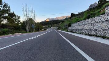 Explore a captivating winding road surrounded by beautiful landscapes and serene vistas, ideal for adventure photo