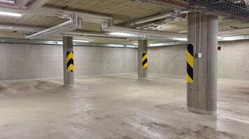 A spacious parking garage with impressive design features and essential safety markings on the pillars photo
