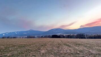 A breathtaking view of rolling hills during twilight hours, showcasing vibrant skies and expansive open fields photo