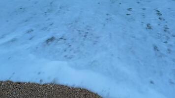 Serene ocean waves are gently crashing softly and rhythmically on the sandy beach during the beautiful twilight hour photo