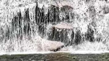 A breathtaking view of a majestic waterfall cascading over rugged rocks a serene natural scene awaits you photo