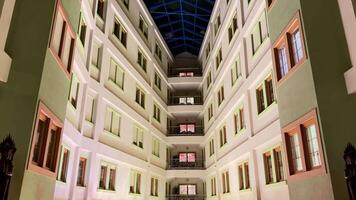 Captivating sight of a stunning modern courtyard showcasing beautiful architectural design and a striking glass ceiling photo