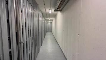 A sleek and minimalistic corridor that is lined with streamlined metal storage units for efficiency and organization photo