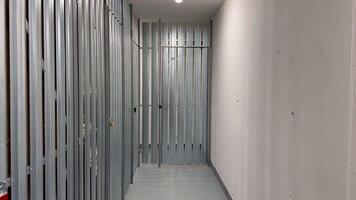 A clean and spacious hallway showcasing metal framing, which is indicative of ongoing construction work activities photo