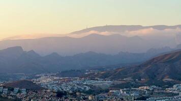 This is a breathtaking view of rolling mountains and fluffy clouds at sunset, showcasing the beauty of nature photo