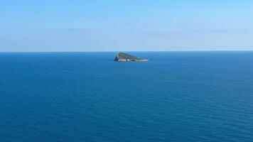 An aerial view beautifully showcases a tranquil ocean gently lapping against a remote island and a vibrant coastline photo