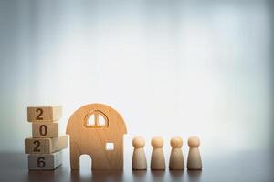 Wooden House with Peg Figures and 2026 Blocks, Symbolizing Home, Family, and Future Plans photo