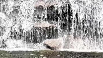 A serene and tranquil view of cascading water flowing gracefully over rocks, capturing the pure beauty of natures flow photo