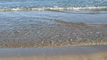 The beautiful ocean waves are gently caressing the soft sandy beach, creating a perfectly tranquil coastal scene photo
