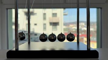 An elegantly crafted depiction of Newtons cradle effectively demonstrating fundamental physics principles photo