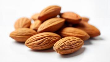 A group of whole almond nuts is isolated on a white background for use in food, nutrition, or snack concepts. The image is suitable for illustrating healthy eating, natural ingredients, or plant-based diets. photo